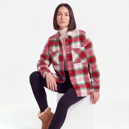 Red Plaid flannel shacket worn over a turtleneck, seated