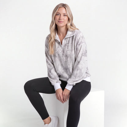 Woman wearing the Gray Tie-Dye quarter zip, seated